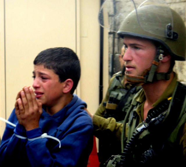 Palestinian boy handcuffed and tortured by Zionist forces