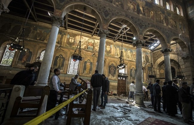 Egyptian security forces and officials inspect the scene of a bomb explosion at the Saint Peter and Saint Paul Coptic Orthodox Church on December 11, 2016, in Cairo's Abbasiya neighborhood. AFP / KHALED DESOUKI