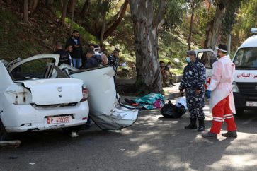 Members of the Lebanese police stand next to a damaged car in Hadath, Lebanon, November 21, 2020. REUTERS/Mohamed Azakir