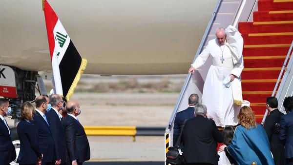 Pope Francis arrives at Baghdad airprot on March 5, 2021 on the first papal visit to Iraq. - Pope Francis began his historic trip to war-scarred Iraq, defying security concerns and the coronavirus pandemic to comfort one of the world's oldest and most persecuted Christian communities. (Photo by Vincenzo PINTO / AFP) (Photo by VINCENZO PINTO/AFP via Getty Images)