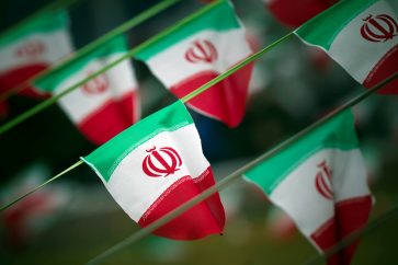 FILE PHOTO: Iran's national flags are seen on a square in Tehran February 10, 2012, a day before the anniversary of the Islamic Revolution. REUTERS/Morteza Nikoubazl/File Photo