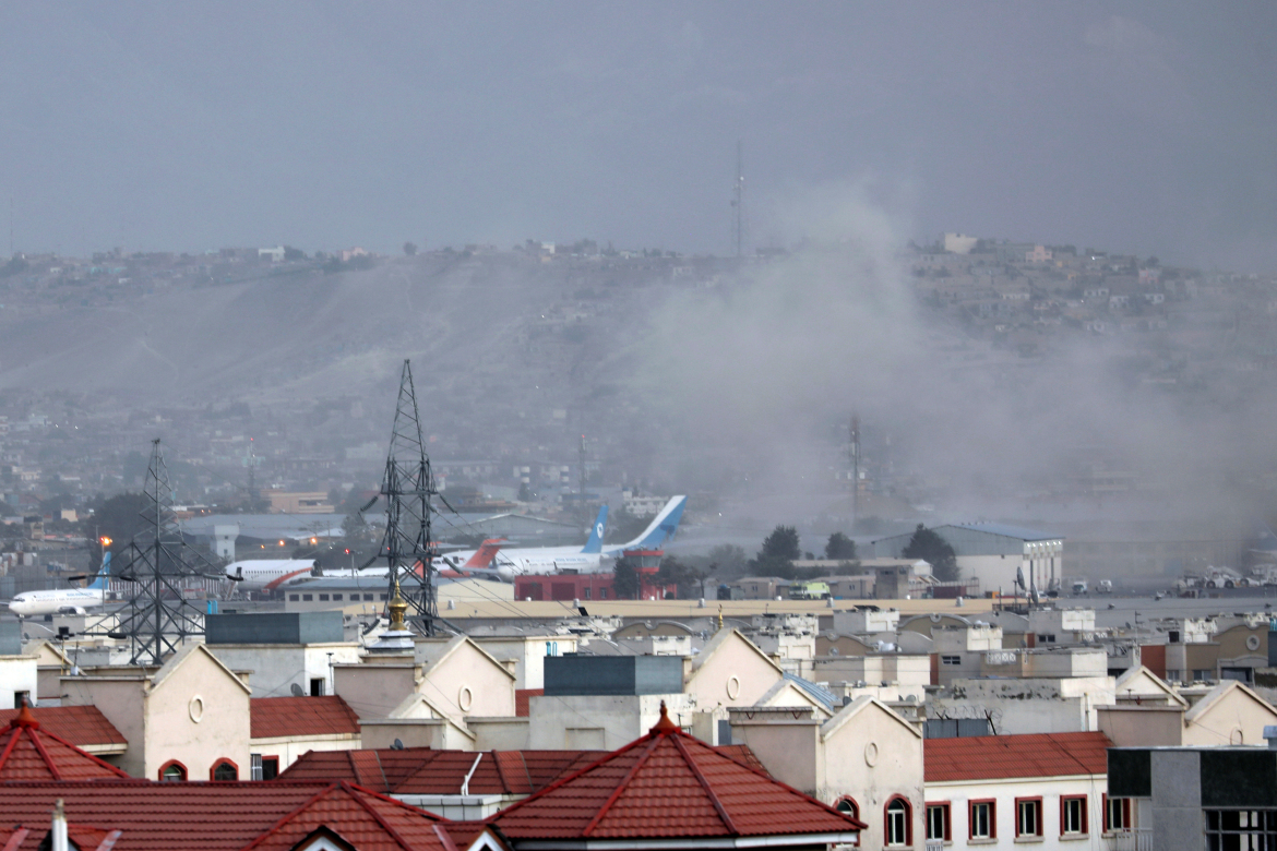 Smoke rises from explosion outside the airport in Kabul, Afghanistan, Thursday, Aug. 26, 2021. The explosion went off outside Kabul’s airport, where thousands of people have flocked as they try to flee the Taliban takeover of Afghanistan. Officials offered no casualty count, but a witness said several people appeared to have been killed or wounded Thursday. (AP Photo/Wali Sabawoon)
