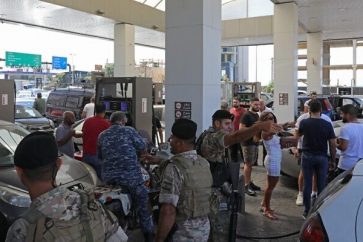 Lebanese soldiers are pictured at a petrol station in the capital Beirut on August 14, 2021, after soldiers were deployed to force several stations to reopen their doors. (Photo by ANWAR AMRO / AFP)