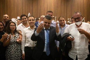 Abdellatif Ouahbi, president of Morocco's Authenticity and Modernity party (C), gestures after his party came in second in the election, with 82 seats