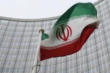 An Iranian flag flutters in front of the IAEA headquarters in Vienna