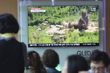 People watch a TV screen showing an image of the dismantling of North Korea's Punggye-ri nuclear test site during a news program at the Seoul Railway Station in Seoul, South Korea, Friday, May 25, 2018. North Korea said Friday that it's still willing to sit down for talks with the United States "at any time, at any format" just hours after President Donald Trump abruptly canceled his planned summit with the North's leader Kim Jong Un. (AP Photo/Ahn Young-joon)