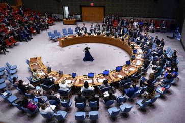 Russian Ambassador Vasily Nebenzya, second from left top, votes no on a procedural vote on whether to allow Ukrainian President Volodymyr Zelenskyy to address the Security Council meeting on threats to international peace and security via video link, Wednesday, Aug. 24, 2022, at United Nations headquarters. (AP Photo/Mary Altaffer)