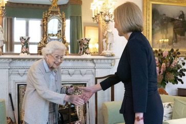 Britain's Queen Elizabeth II, left, welcomes Liz Truss during an audience at Balmoral, Scotland, where she invited the newly elected leader of the Conservative party to become Prime Minister and form a new government, Tuesday, Sept. 6, 2022. (Jane Barlow/Pool Photo via AP)