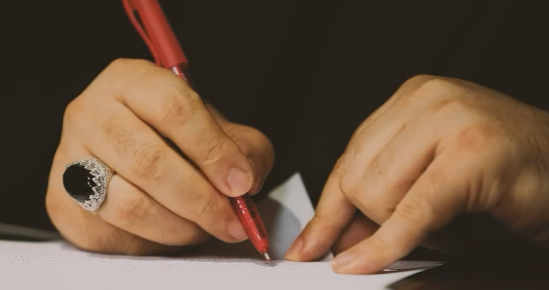 Sayyed Nasrallah Writing a Message to Martyrs' Families