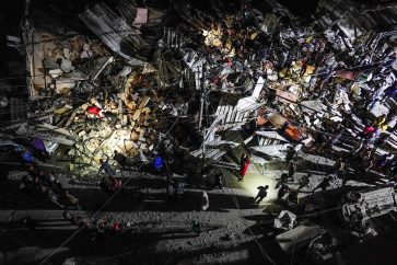 Palestinians sift through the rubble of a building following an Israeli bombardment in Nuseirat in the central Gaza Strip late on May 13, 2024, amid the ongoing conflict between Israel and the militant group Hamas. (Photo by AFP)