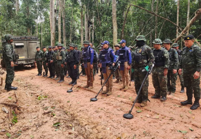 Thai soldiers inspect a border area in Ubon Ratchathani province where they claim to have found two anti-personnel landmines. Photograph: AP