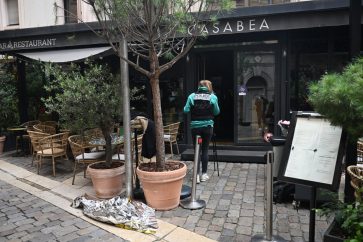 A French police officer inspects the site of a gas explosion at a restaurant in Lyon on September 30, 2025. According to local media several people were injured and no casualties were reported in the incident. (Photo by Olivier CHASSIGNOLE / AFP)